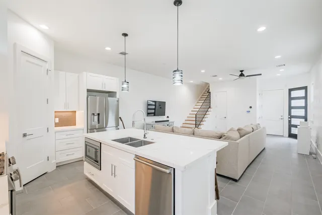 a kitchen with a table chairs refrigerator and microwave