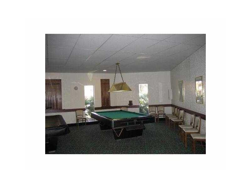 200 Gate Road, Unit 211 Hollywood, FL 33024 - Photo 12 of 16 a living room with furniture and a table