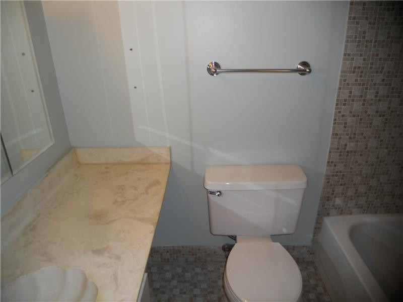 200 Gate Road, Unit 211 Hollywood, FL 33024 - Photo 8 of 16 a white toilet sitting next to a bathroom sink