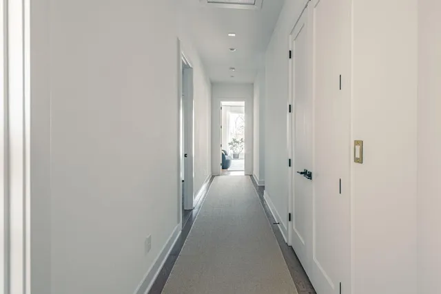 a view of a hallway with a wooden floor