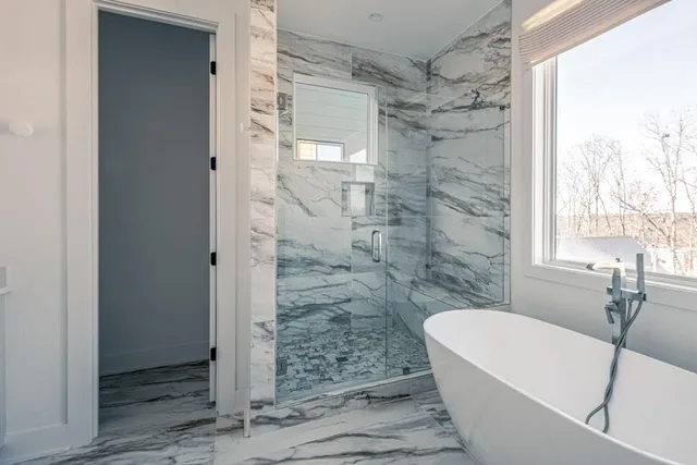 a bathroom with a bathtub and a shower