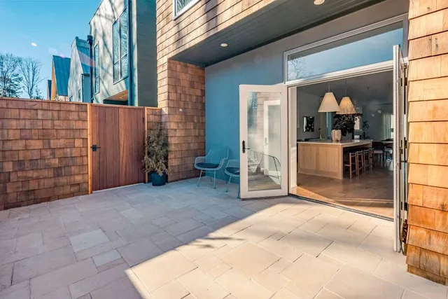 a view of a porch with a table and chairs and potted plants