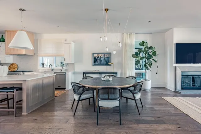 a kitchen with cabinets table and chairs
