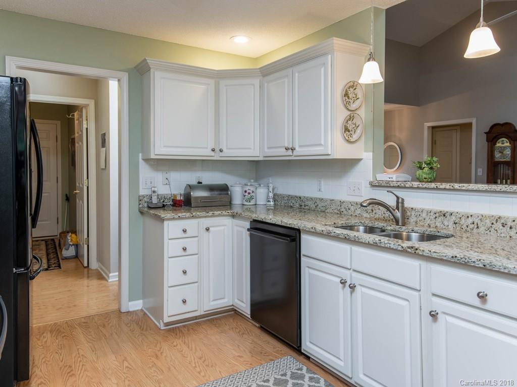 232 Stonehollow Road Fletcher, NC 28732 - Photo 11 of 35 a kitchen with granite countertop white cabinets and stainless steel appliances