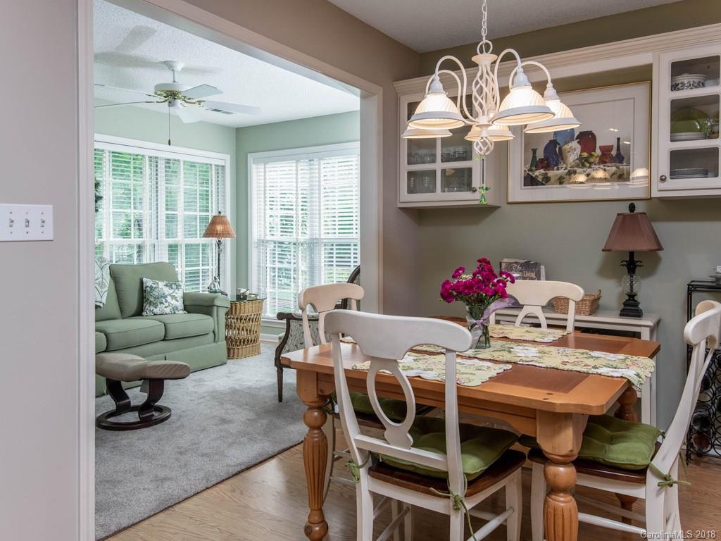 232 Stonehollow Road Fletcher, NC 28732 - Photo 13 of 35 a view of a dining room with furniture a chandelier and wooden floor