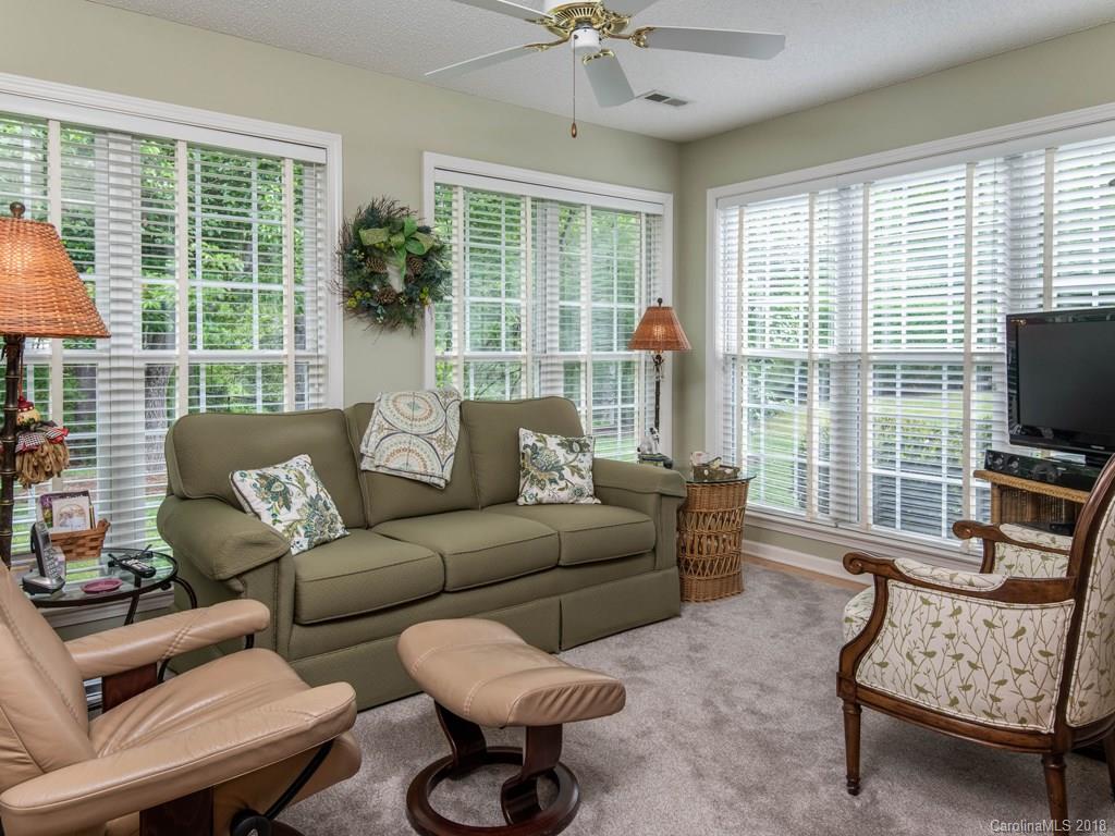 232 Stonehollow Road Fletcher, NC 28732 - Photo 14 of 35 a living room with furniture a flat screen tv and a floor to ceiling window