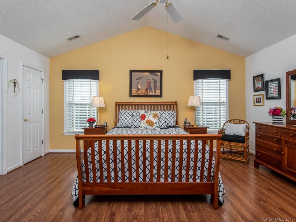 232 Stonehollow Road Fletcher, NC 28732 - Photo 17 of 35 a bedroom with a bed and wooden floor