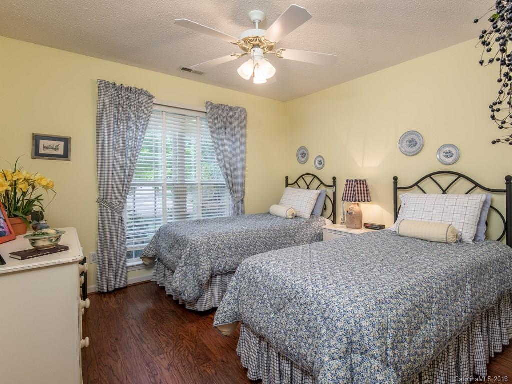 232 Stonehollow Road Fletcher, NC 28732 - Photo 21 of 35 a bedroom with two beds and a chandelier