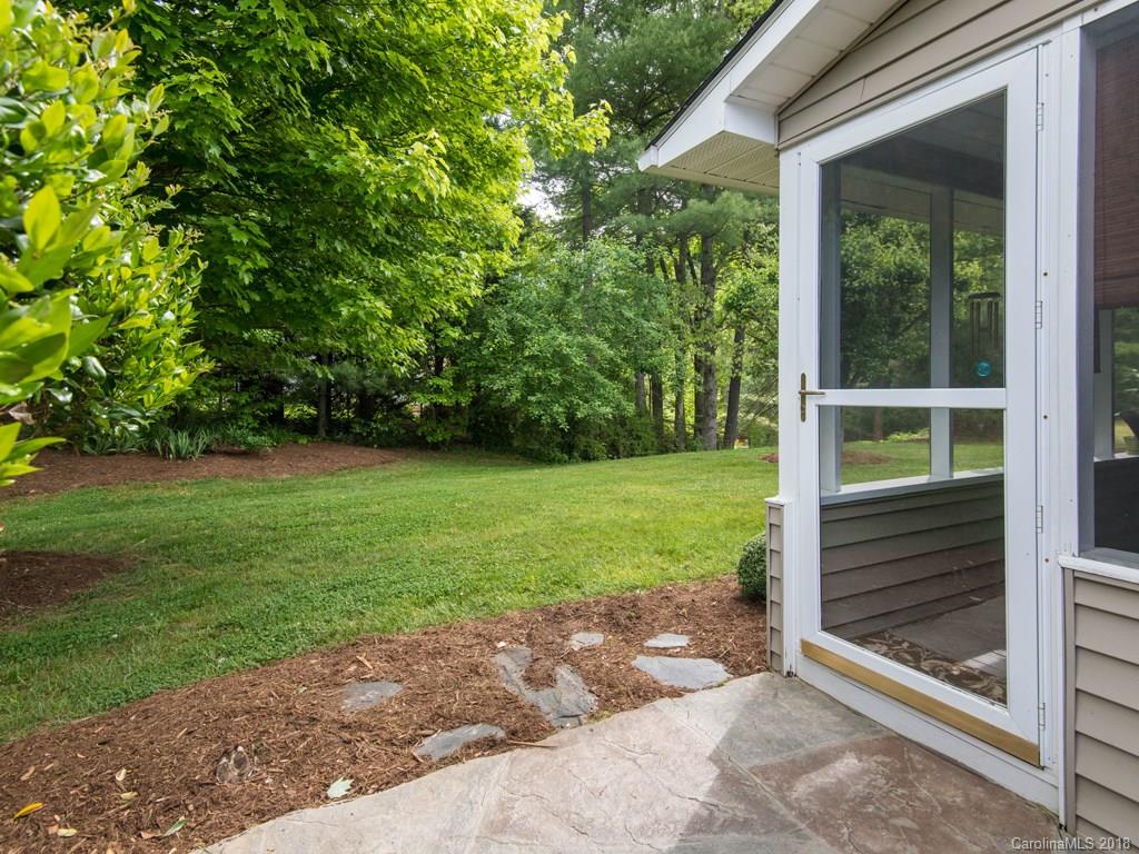 232 Stonehollow Road Fletcher, NC 28732 - Photo 27 of 35 a backyard of a house with plants and garden