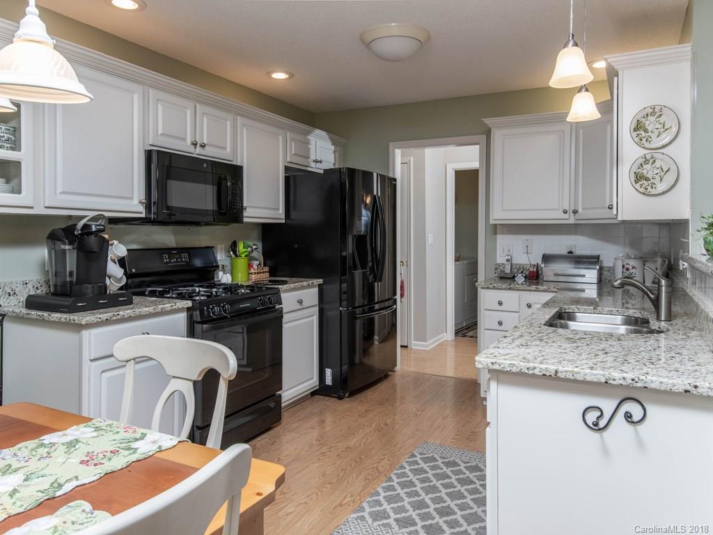 232 Stonehollow Road Fletcher, NC 28732 - Photo 10 of 35 a kitchen with stainless steel appliances granite countertop a sink stove refrigerator granite counter tops and white cabinets