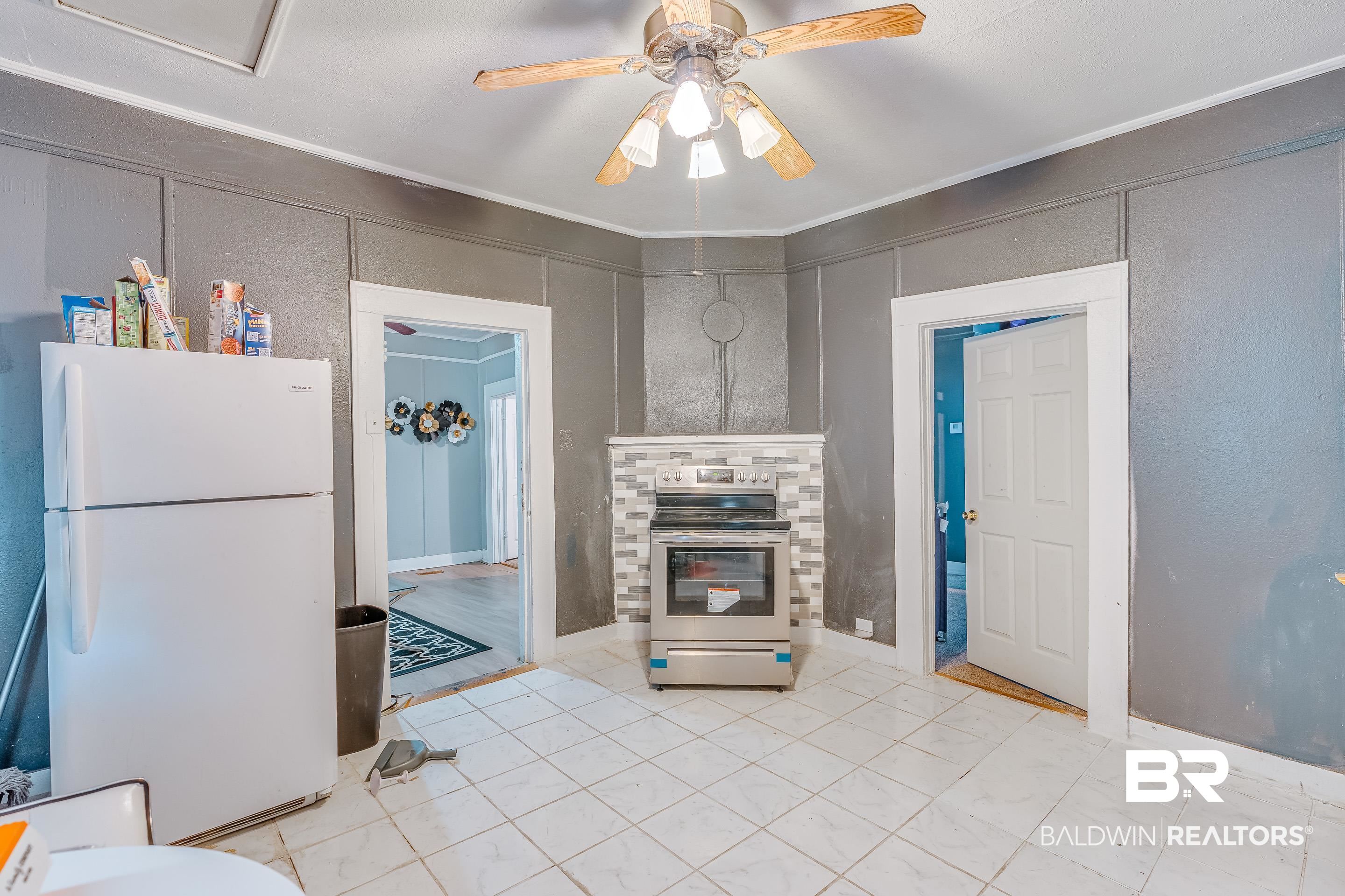 14 Southern Street Mobile, AL 36611 - Photo 7 of 26 Kitchen with electric range, ornamental molding, ceiling fan, and white fridge