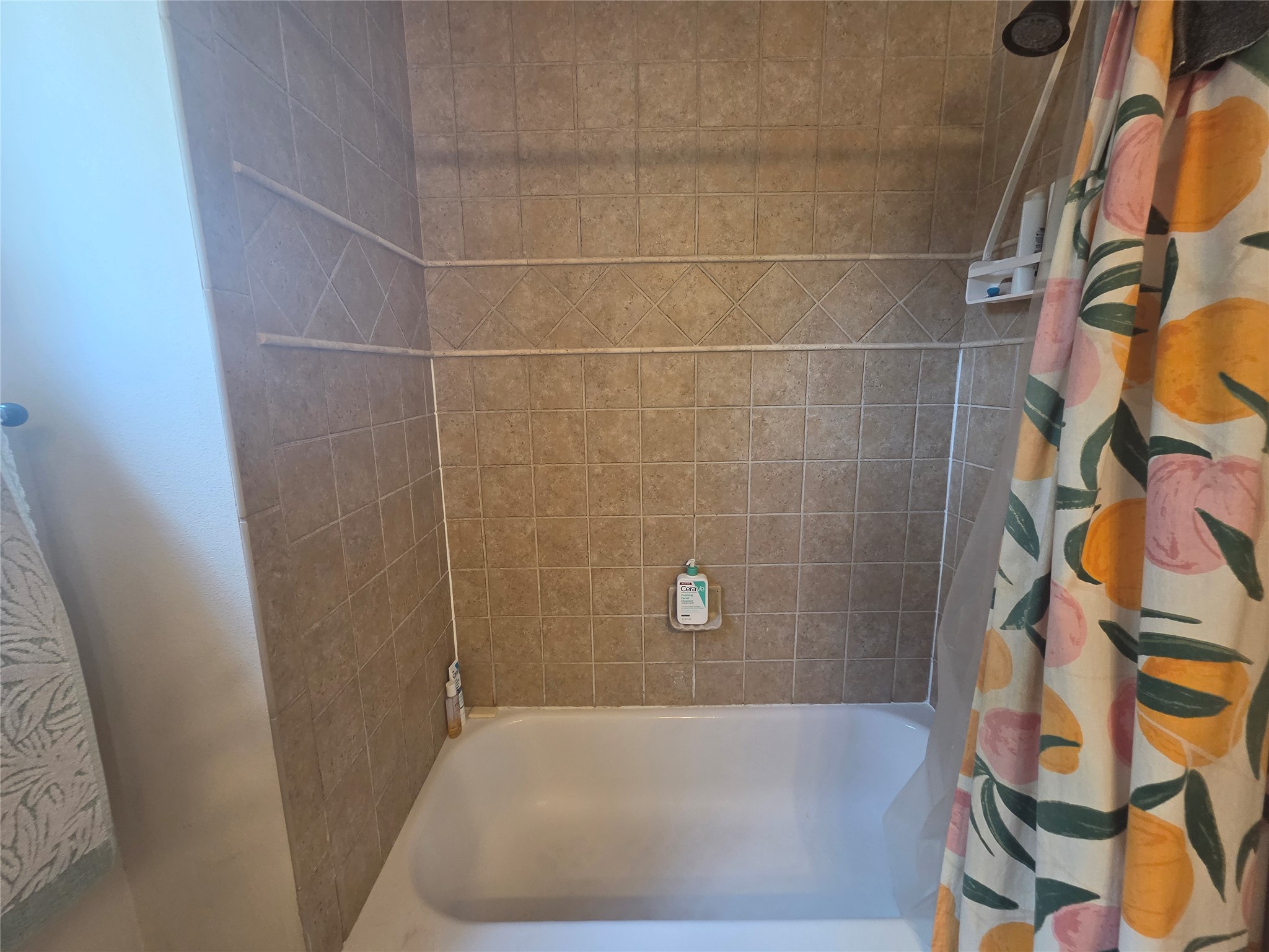 408 West Croslin Street Austin, TX 78752 - Photo 22 of 29 Functional bath and shower combination with neutral tiling offers daily convenience.