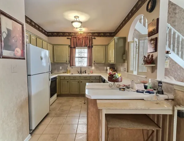 a kitchen with a sink appliances and cabinets