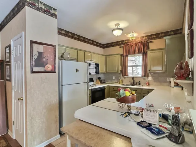 a kitchen with a refrigerator and a sink