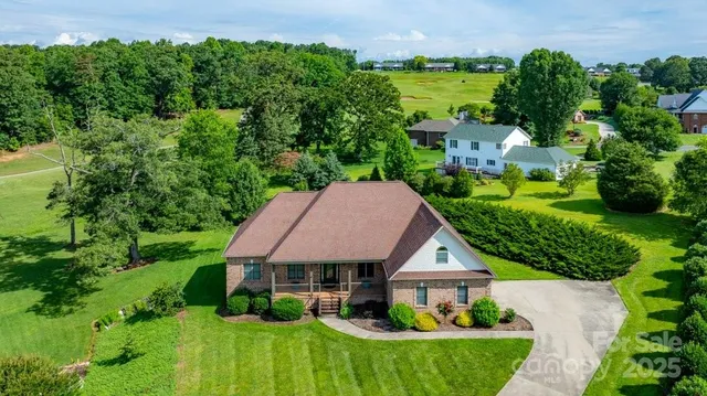 an aerial view of a house with garden space and street view