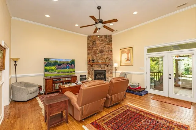 a living room with fireplace furniture and a flat screen tv