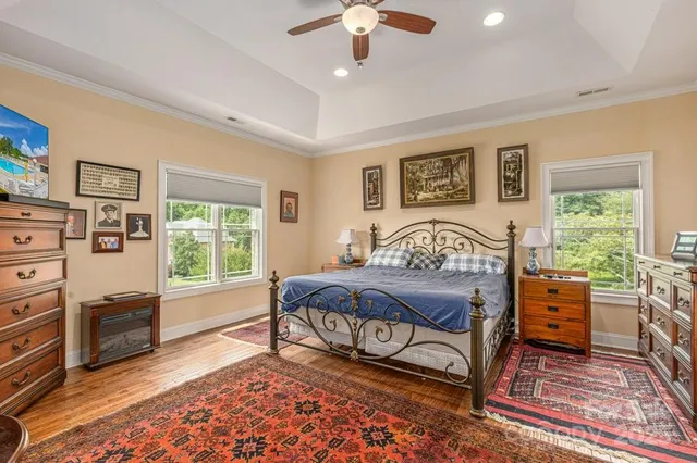 a bedroom with a bed and a chandelier