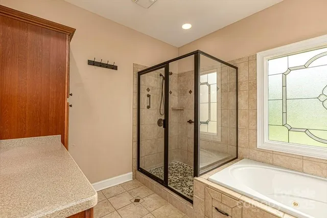 a bathroom with a tub and shower