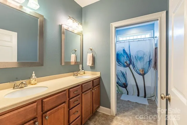 a bathroom with a double vanity sink and a mirror