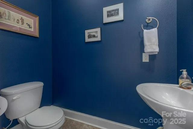 a white toilet sitting next to a bathroom sink