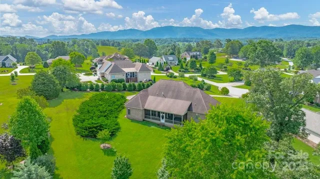 an aerial view of a house with a garden and a yard