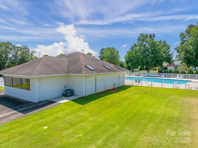 a view of a swimming pool with a yard