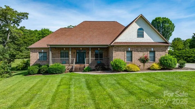 a front view of a house with a yard and porch