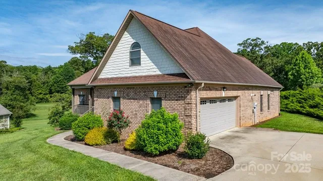 a front view of a house with a yard garage and outdoor seating