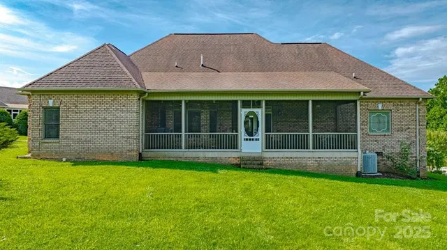 a front view of a house with a garden and yard