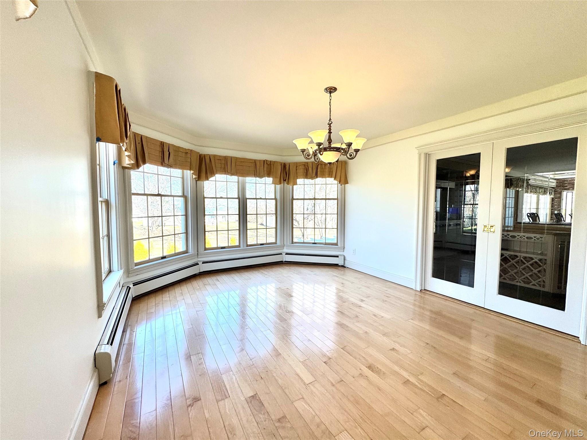 886 Sound Shore Road Riverhead, NY 11901 - Photo 14 of 39 Dining room with hardwood floors and French doors to front porch
