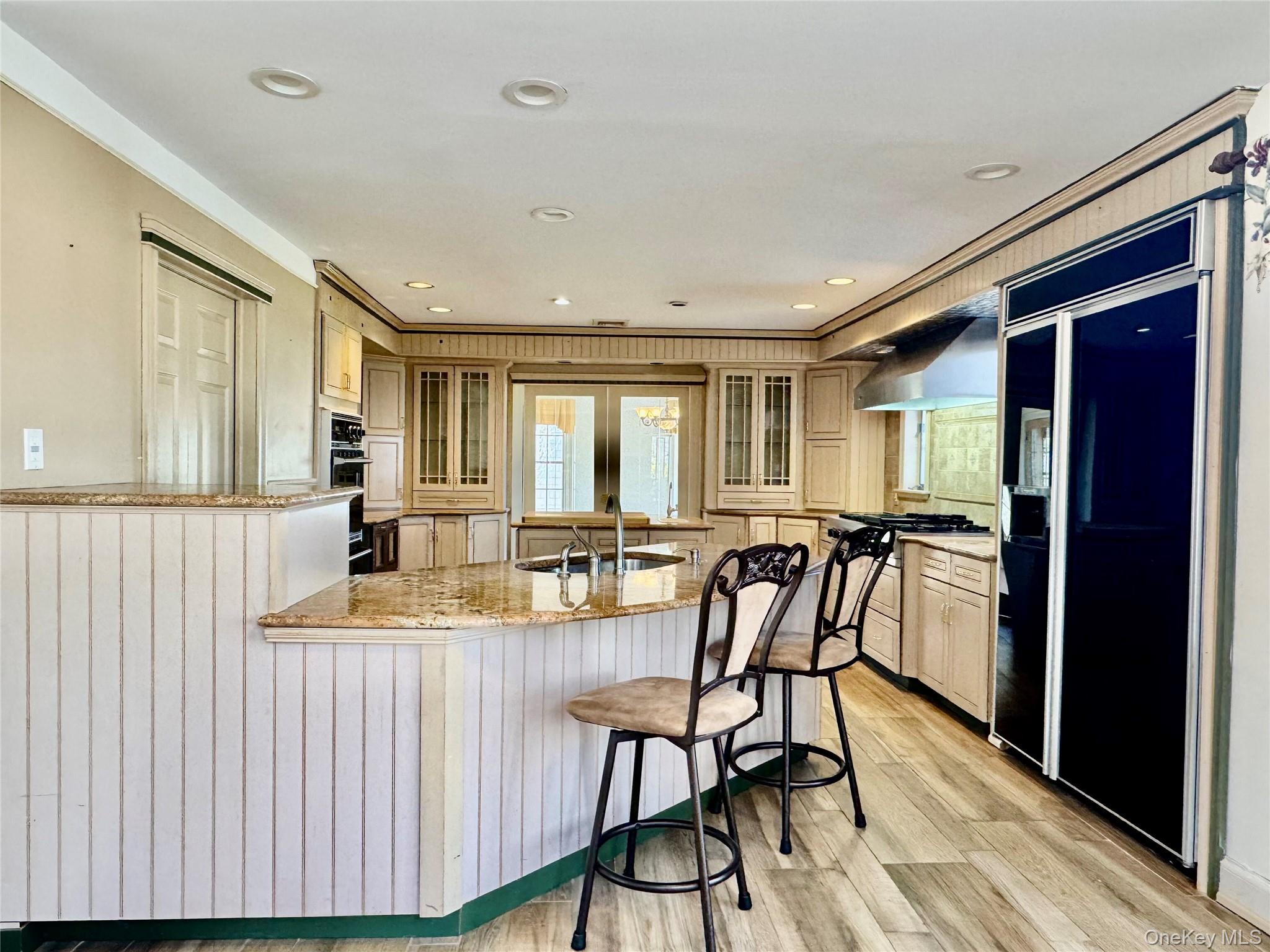 886 Sound Shore Road Riverhead, NY 11901 - Photo 16 of 39 Custom cabinets, granite countertops and peninsula with a raised dishwasher