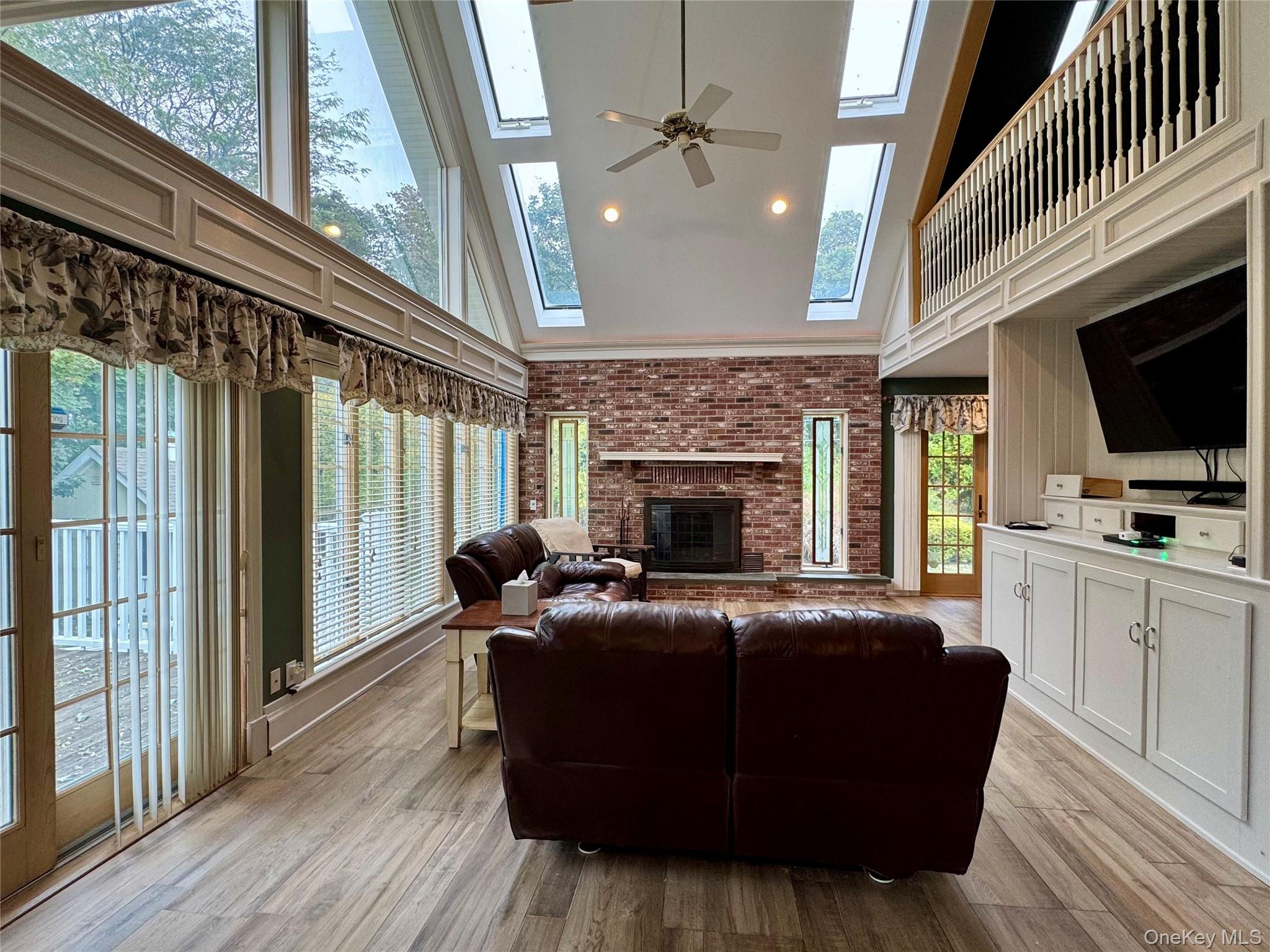 886 Sound Shore Road Riverhead, NY 11901 - Photo 20 of 39 Den with wide plank floors with radiant heat, wood burning fire place and skylights