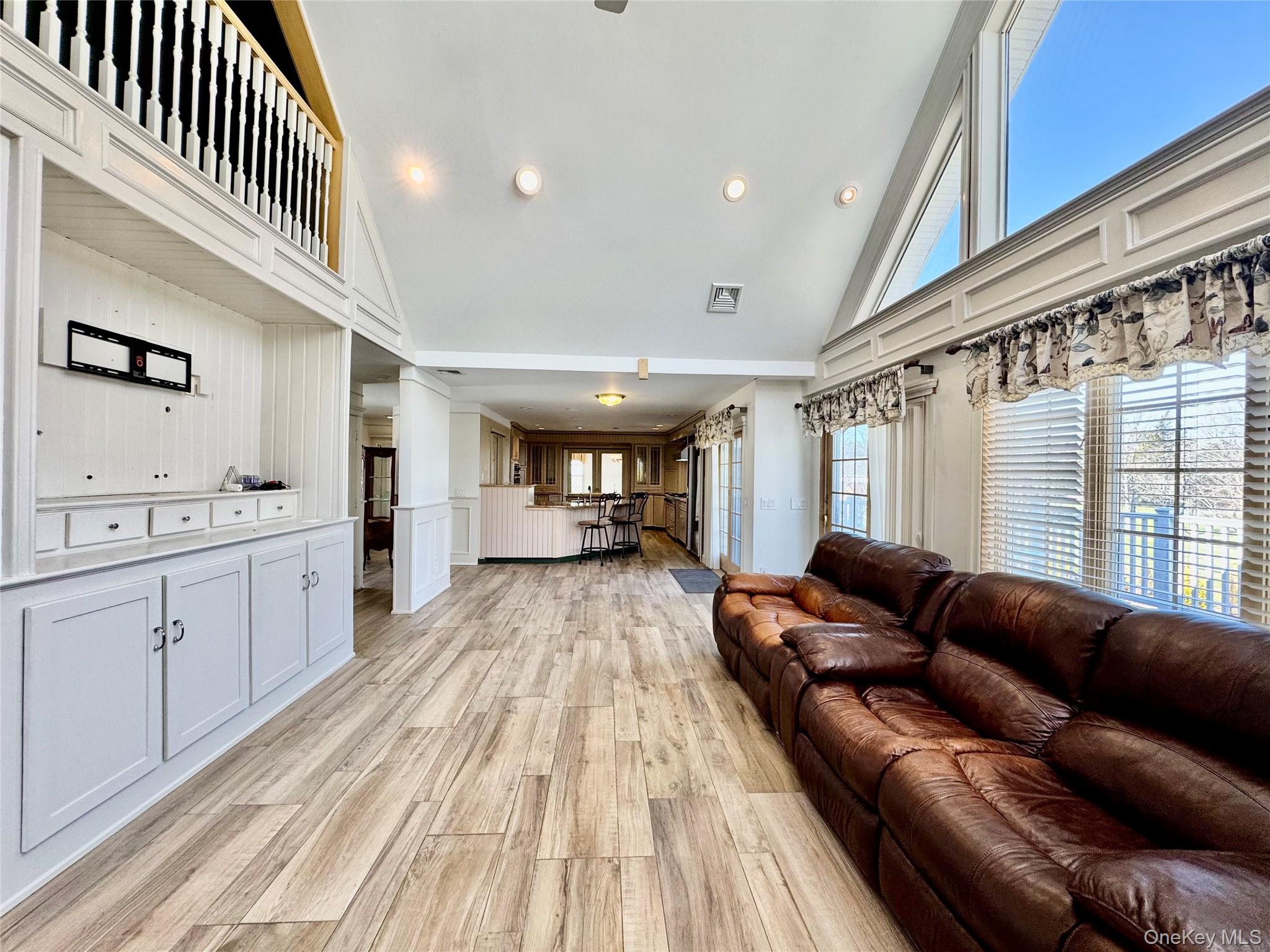 886 Sound Shore Road Riverhead, NY 11901 - Photo 21 of 39 light and airy den open to the kitchen with sliding doors to the deck