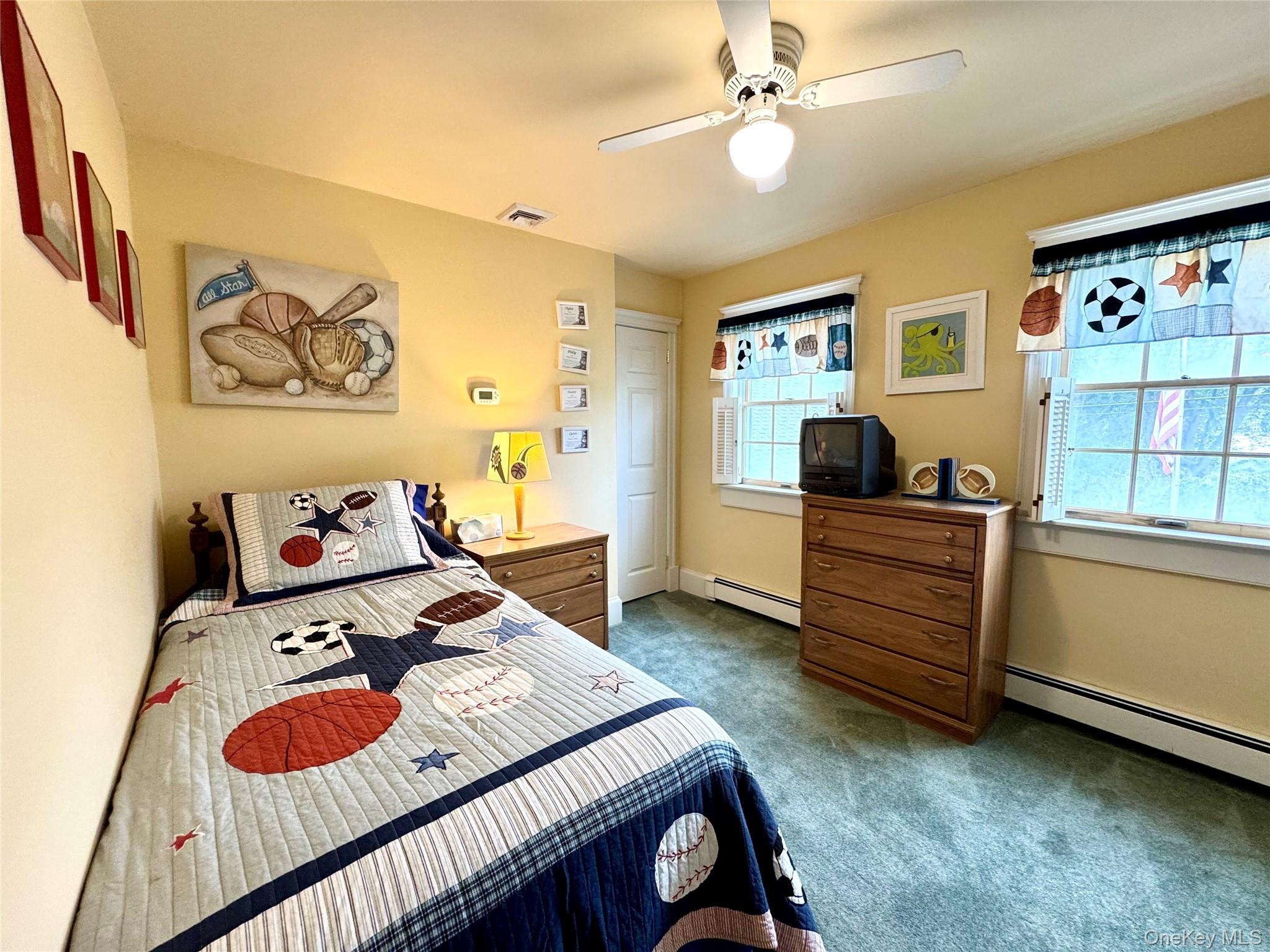 886 Sound Shore Road Riverhead, NY 11901 - Photo 31 of 39 4th bedroom with large windows and a ceiling fan