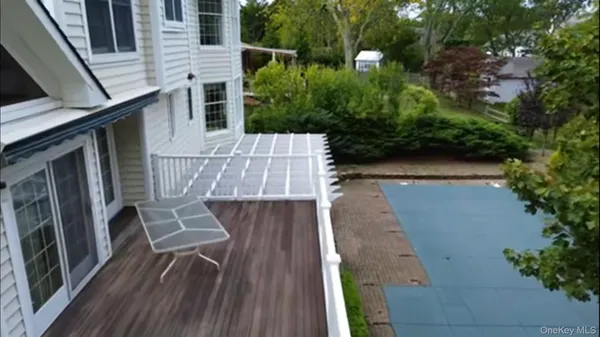 a view of balcony with wooden floor and outdoor seating