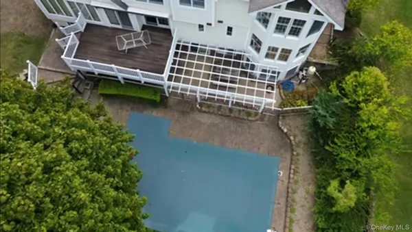 an aerial view of a house with a yard and lake view