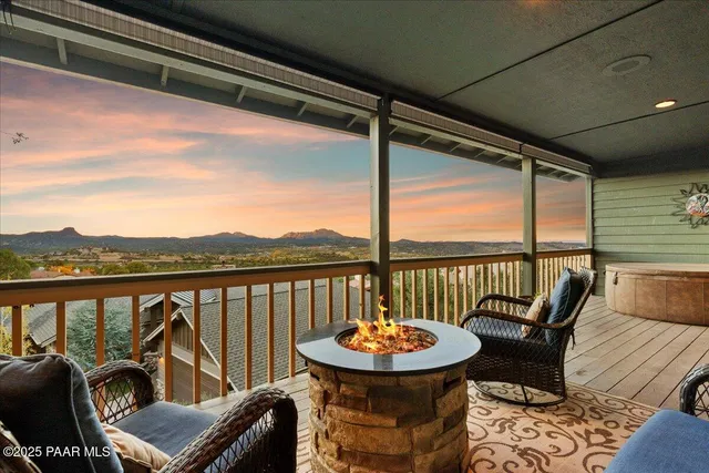 a living room with furniture floor to ceiling window and flat screen tv