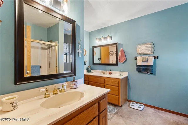 a bathroom with a double vanity sink and a mirror