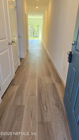 a view of hallway with wooden floor