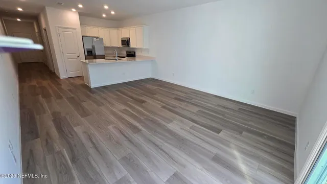 a kitchen with stainless steel appliances kitchen island sink refrigerator and stove