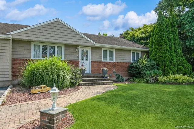 a view of a house with a yard and furniture