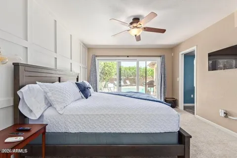 a bedroom with a large bed and a chandelier