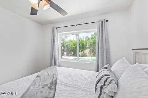 a bedroom with a bed and a window