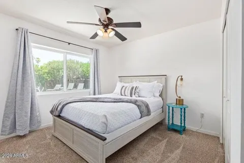 a bed sitting in a bedroom next to a window