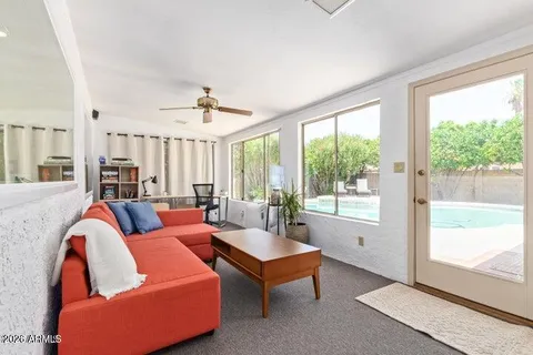 a living room with furniture and a large window