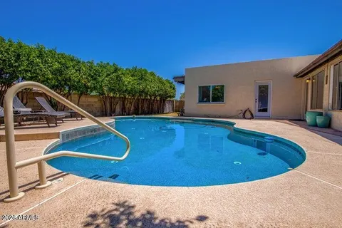 a view of swimming pool with a backyard