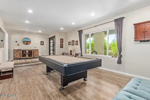 a room with pool table and windows