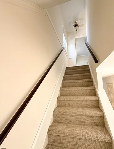 a bathroom with a granite countertop sink a toilet and a mirror