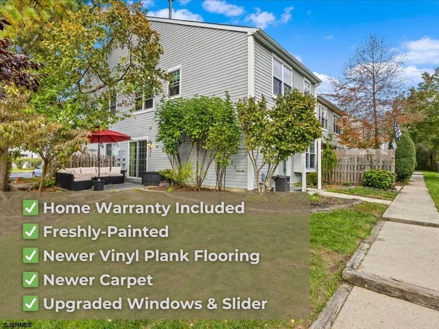 a view of a patio with table and chairs under an umbrella