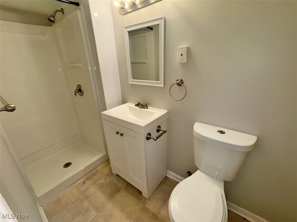 28642 Forest Road Willowick, OH 44095 - Photo 23 of 23 Bathroom with a shower stall, vanity, and light tile patterned floors